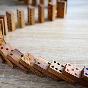 Dominoes arranged on a wooden table - Leep Tescher Helfman and Zanze