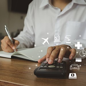 Focused person calculates travel expenses with calculator & notebook, surrounded by icons - Leep Tescher Helfman and Zanze