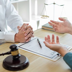 A person discussing a workers’ compensation appeal with a lawyer. - Leep Tescher Helfman and Zanze