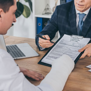 Attorney reviewing legal documents with an injured client